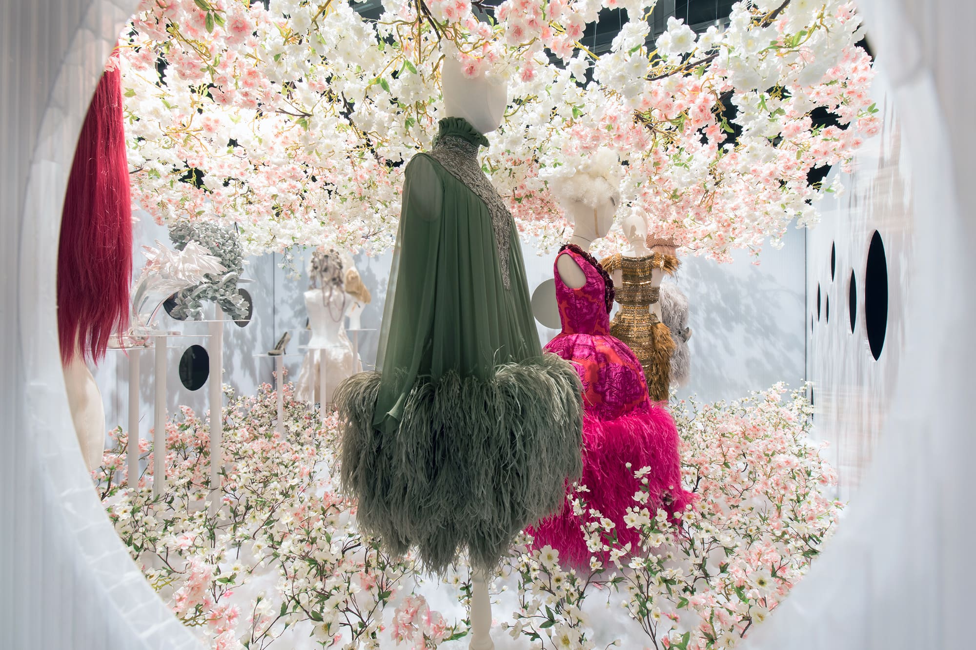 mannequins in a room with flowers and dresses