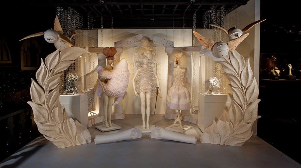 a mannequins in a room with white and gold decorations
