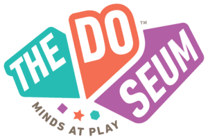 The DoSeum logo with colorful geometric shapes, the words "THE DO SEUM," and the slogan "Minds at Play" underneath highlights its connection to traveling exhibitions that inspire learning and creativity.