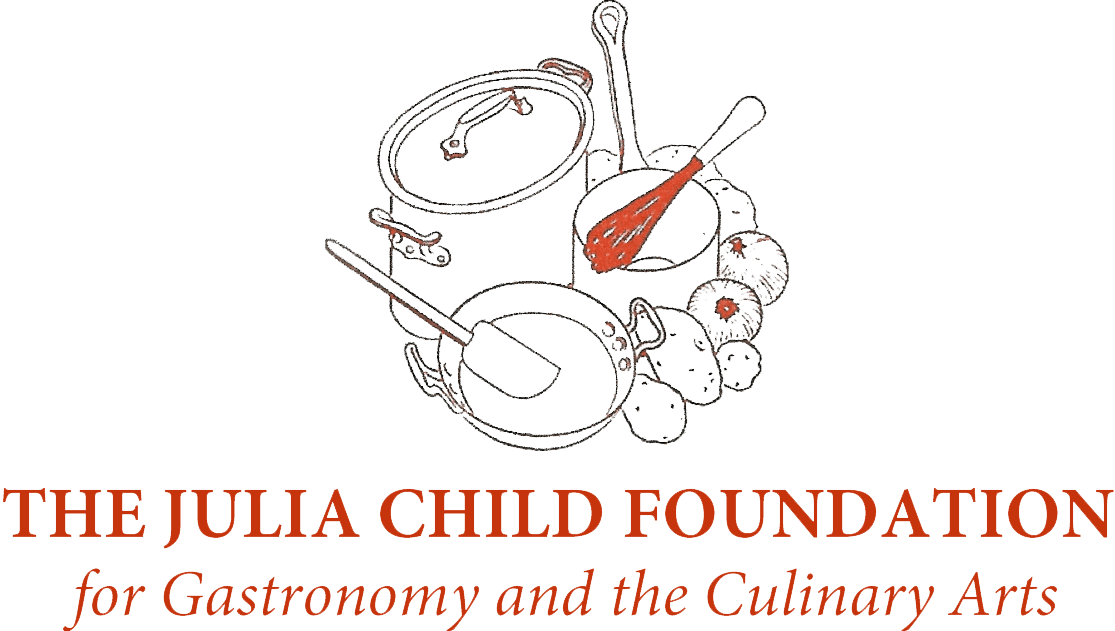 Logo for The Julia Child Foundation for Gastronomy and the Culinary Arts, leading producer of traveling exhibitions, featuring outlined kitchen utensils and vegetables above the organization’s name in red text.