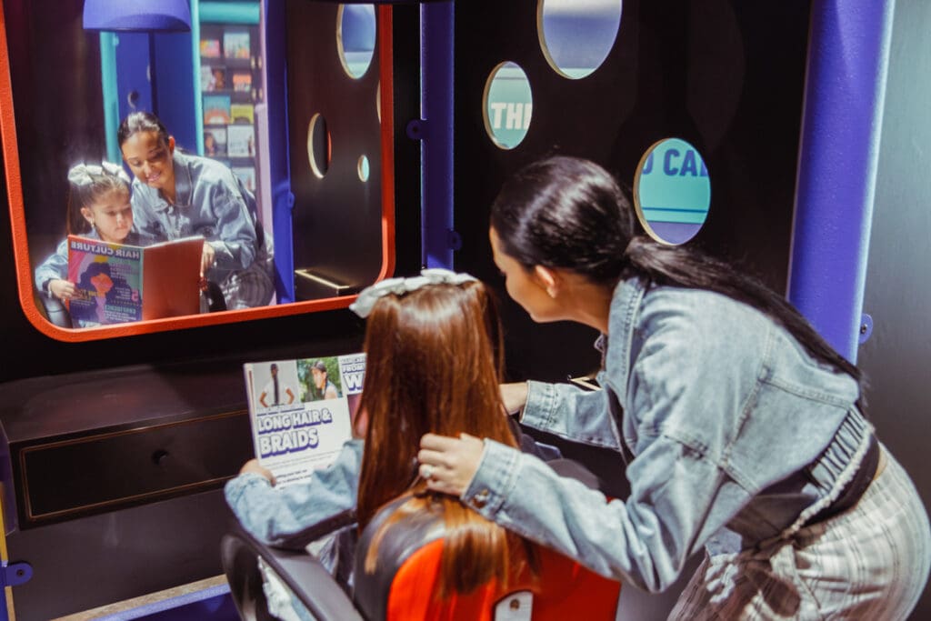 Two people interacting in a salon.