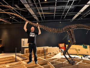 Trent posing with dinosaur skeleton installation