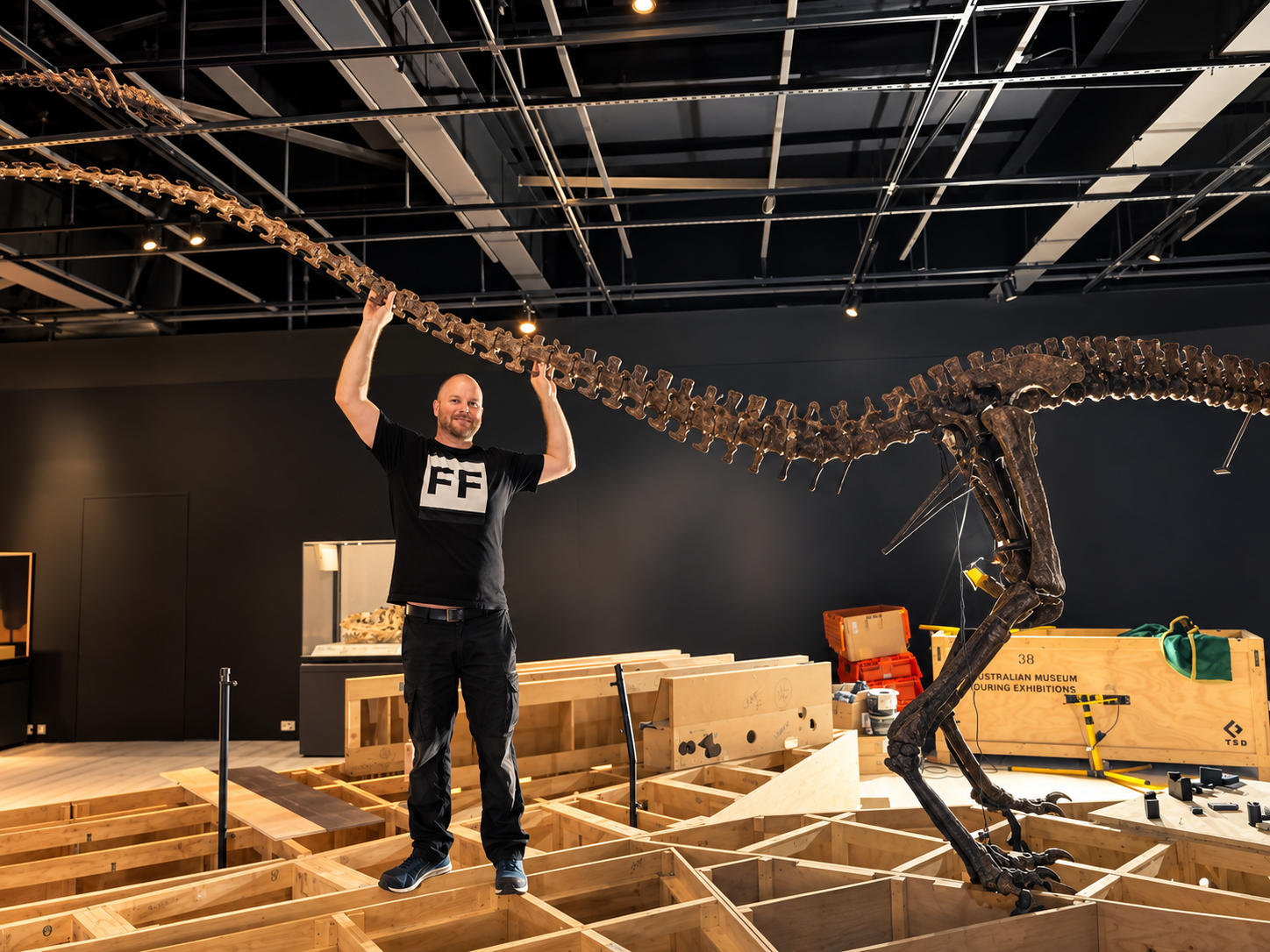 Trent posing with dinosaur skeleton installation