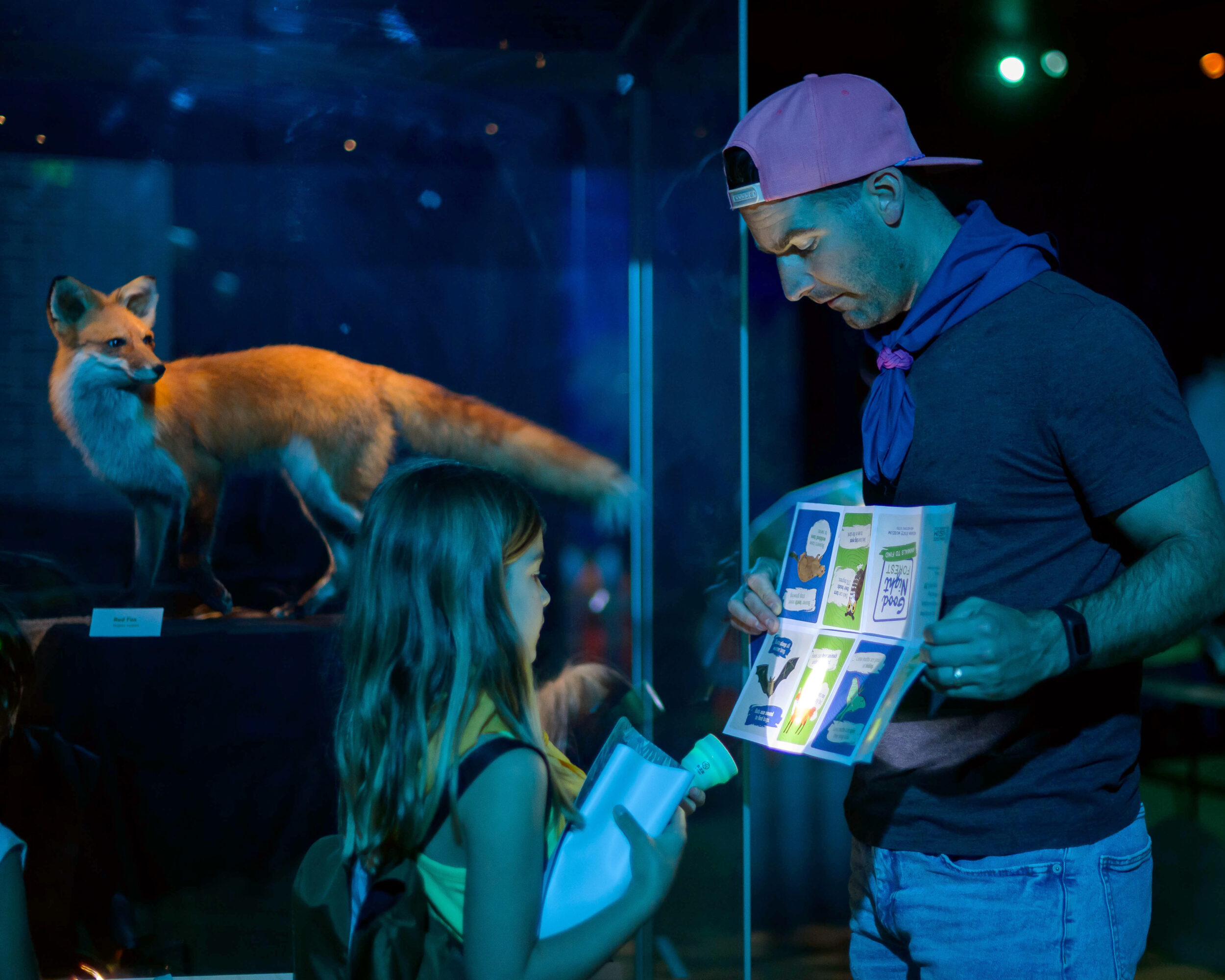 Man and child at museum exhibition Good Night Forest